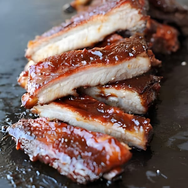 Close-up of several juicy, saucy BBQ ribs from Busters Southern Pit BBQ.