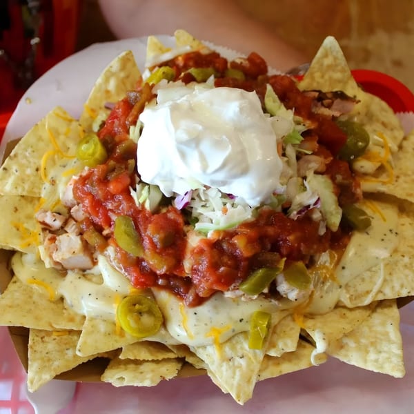 Buster's Southern Pit BBQ nachos with cheese, salsa, sour cream, jalapeños, and chicken.